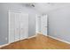 Bedroom with closet, wood floors and neutral color palette provide a calming and functional space at 13219 Meadowlark Ln, Orlando, FL 32828