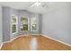 Bedroom bathed in light with multiple windows, wood floors, and neutral walls for a serene atmosphere at 13219 Meadowlark Ln, Orlando, FL 32828