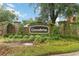 Landscaped Greenbriar community entrance sign with brick pillars covered in climbing ivy at 13219 Meadowlark Ln, Orlando, FL 32828