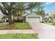 Charming single-story home with a two-car garage, mature landscaping, and a lovely shade tree at 13219 Meadowlark Ln, Orlando, FL 32828