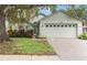 Well-maintained single-story home with large two-car garage and mature landscaping in front at 13219 Meadowlark Ln, Orlando, FL 32828