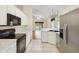 Bright kitchen featuring stainless steel appliances, white cabinets, and an open layout to the living space at 13219 Meadowlark Ln, Orlando, FL 32828