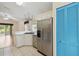 Open kitchen with stainless steel appliances, blue closet doors, and view to the backyard at 13219 Meadowlark Ln, Orlando, FL 32828