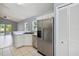 Efficient kitchen featuring stainless steel appliances, white cabinetry, and easy access to the outdoor area at 13219 Meadowlark Ln, Orlando, FL 32828