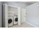 Convenient laundry room with a washer, dryer, shelving, and storage space for efficient household tasks at 13219 Meadowlark Ln, Orlando, FL 32828