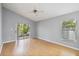 Bright living room with sliding glass doors to the screened in porch, gray walls, and light wood flooring at 13219 Meadowlark Ln, Orlando, FL 32828