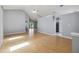 Bright living room with high ceilings, modern gray walls, and light wood flooring overlooking the kitchen at 13219 Meadowlark Ln, Orlando, FL 32828