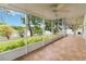 Enclosed porch with water view; features tile flooring, ceiling fans, and durable screening at 13219 Meadowlark Ln, Orlando, FL 32828