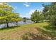 Beautiful waterfront backyard with mature trees at 13219 Meadowlark Ln, Orlando, FL 32828