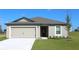 Charming single-story home featuring a two-car garage, well-maintained lawn, and classic architectural details at 354 Bowfin Ct, Poinciana, FL 34759