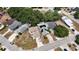 Overhead drone view of neighborhood with mature trees shading houses and quiet streets at 640 Lake Dexter Cir, Winter Haven, FL 33884