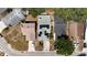 Aerial view of house with solar panels on the roof and a car parked in the driveway at 640 Lake Dexter Cir, Winter Haven, FL 33884