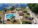 Aerial view of the property with a swimming pool, playground and access to the lake at 640 Lake Dexter Cir, Winter Haven, FL 33884