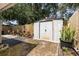 Private backyard featuring a storage shed, patio, and lush greenery at 640 Lake Dexter Cir, Winter Haven, FL 33884