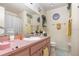 Bathroom featuring a pink vanity with a white sink, a large mirror, and updated fixtures at 640 Lake Dexter Cir, Winter Haven, FL 33884