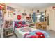 Bright bedroom featuring superhero-themed decor, study space, and comfortable furnishings at 640 Lake Dexter Cir, Winter Haven, FL 33884
