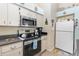 A kitchen with stainless steel appliances, ample counter space, and white cabinets at 640 Lake Dexter Cir, Winter Haven, FL 33884