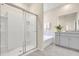 Modern bathroom featuring a glass shower, a tub, and gray vanity at 7634 Oakmoss Loop, Davenport, FL 33837