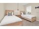 Cozy bedroom featuring twin beds with stylish headboards, matching nightstands, and a bright window with blinds at 7634 Oakmoss Loop, Davenport, FL 33837