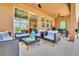 Comfortable screened-in patio with lounge seating, a ceiling fan, and easy access to the living area at 7634 Oakmoss Loop, Davenport, FL 33837