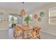 Bright dining room featuring a wooden table with seating and sliding glass doors to an outdoor patio area at 7634 Oakmoss Loop, Davenport, FL 33837