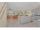 Open concept kitchen with gray cabinets, a granite island, stainless steel appliances, and easy access to the living room at 7634 Oakmoss Loop, Davenport, FL 33837
