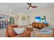 Bright and airy living room featuring a leather couch, stylish decor, and an open layout at 7634 Oakmoss Loop, Davenport, FL 33837