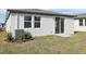Backyard with fresh sod, offering a clean slate for gardening and outdoor activities, with a sliding glass door entry at 2530 Linda Knoll Ln, Bartow, FL 33830