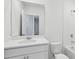 Bathroom with a large mirror over a sink, toilet, and shower-tub combo at 2530 Linda Knoll Ln, Bartow, FL 33830