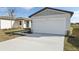 The house features a two-car garage and a freshly landscaped front yard at 2530 Linda Knoll Ln, Bartow, FL 33830