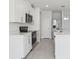 Modern kitchen with stainless steel appliances, white cabinets and quartz countertops at 2530 Linda Knoll Ln, Bartow, FL 33830