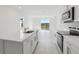 A well-lit kitchen with an island sink, stainless steel appliances, and patio doors at 2530 Linda Knoll Ln, Bartow, FL 33830