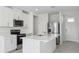 Modern kitchen with stainless steel appliances, white cabinets and quartz countertops, next to entrance at 2530 Linda Knoll Ln, Bartow, FL 33830