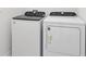 Laundry room with modern white Whirlpool washer and dryer machines at 2530 Linda Knoll Ln, Bartow, FL 33830