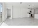 Bright living area with tile flooring features a sliding glass door and white kitchen in the background at 2530 Linda Knoll Ln, Bartow, FL 33830