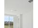 Bright and airy living room with white walls and tile flooring, features access to the outside at 2530 Linda Knoll Ln, Bartow, FL 33830