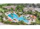 Aerial view of a large community pool area with palm trees and plenty of lounge chairs at 8691 Sw 57Th Ln, Ocala, FL 34481