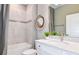 Elegant bathroom features a shower-tub combo, designer mirror, and vanity with modern fixtures at 8691 Sw 57Th Ln, Ocala, FL 34481