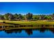 Picturesque golf course view with lush green fairways, mature trees, and a serene pond at 8691 Sw 57Th Ln, Ocala, FL 34481