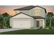 Charming two-story home with a two-car garage, landscaped yard, and classic architectural details at 9052 Wildlight Trl, Wildwood, FL 34785