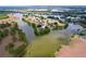 An expansive aerial view of a lake community showcasing waterfront properties and a scenic setting at 1634 Lady Bowers Trl, Lakeland, FL 33809