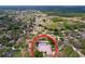 Aerial view of a neighborhood featuring mature trees and a home with a private screened-in pool at 1634 Lady Bowers Trl, Lakeland, FL 33809