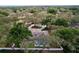 Aerial view of a home with screened-in pool surrounded by lush trees and a white fence at 1634 Lady Bowers Trl, Lakeland, FL 33809
