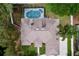 Aerial view of a home with a screened-in pool, showcasing the roof and surrounding trees, offering a private outdoor space at 1634 Lady Bowers Trl, Lakeland, FL 33809