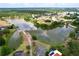 Aerial view of a lake community, highlighting mature trees and waterfront homes at 1634 Lady Bowers Trl, Lakeland, FL 33809