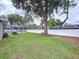 Well-manicured backyard with lush greenery, a white fence, and a screened-in pool area at 1634 Lady Bowers Trl, Lakeland, FL 33809