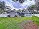 Expansive backyard featuring a lush lawn and a screened-in pool area at 1634 Lady Bowers Trl, Lakeland, FL 33809
