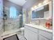 Bathroom featuring a tiled shower, modern vanity, sink, mirror, and stylish finishes at 1634 Lady Bowers Trl, Lakeland, FL 33809