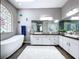 Bright bathroom featuring a freestanding tub, decorative stained glass window, and double vanity with modern fixtures at 1634 Lady Bowers Trl, Lakeland, FL 33809