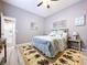 Charming bedroom with a palm tree rug, ceiling fan, and ensuite bathroom access at 1634 Lady Bowers Trl, Lakeland, FL 33809